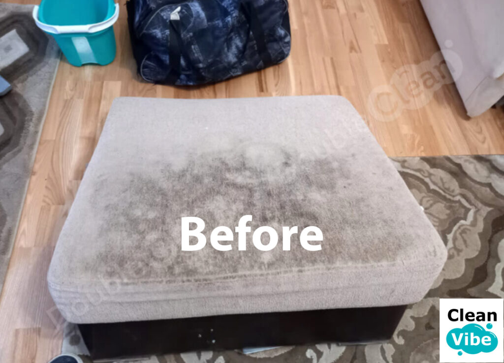 Close-up of ottoman showing stain removal process - before and after cleaning results